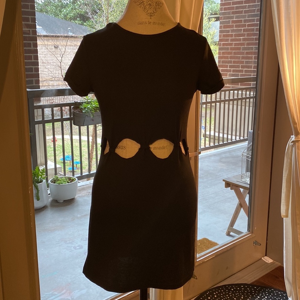Small black shortsleeve dress with cut outs and knots at stomach waist level​